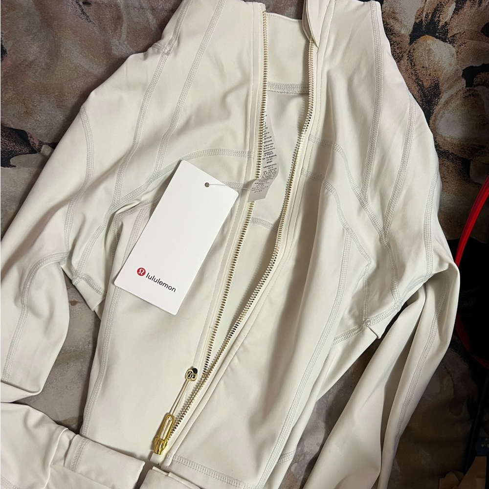 (white and gold lululemon jacket)